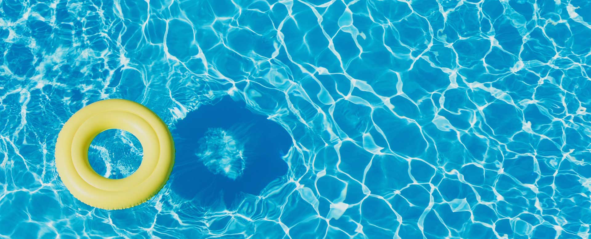 Yellow ring float on clear blue pool water