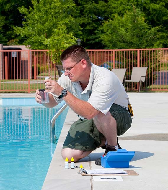 Poolmasters technician testing pool water